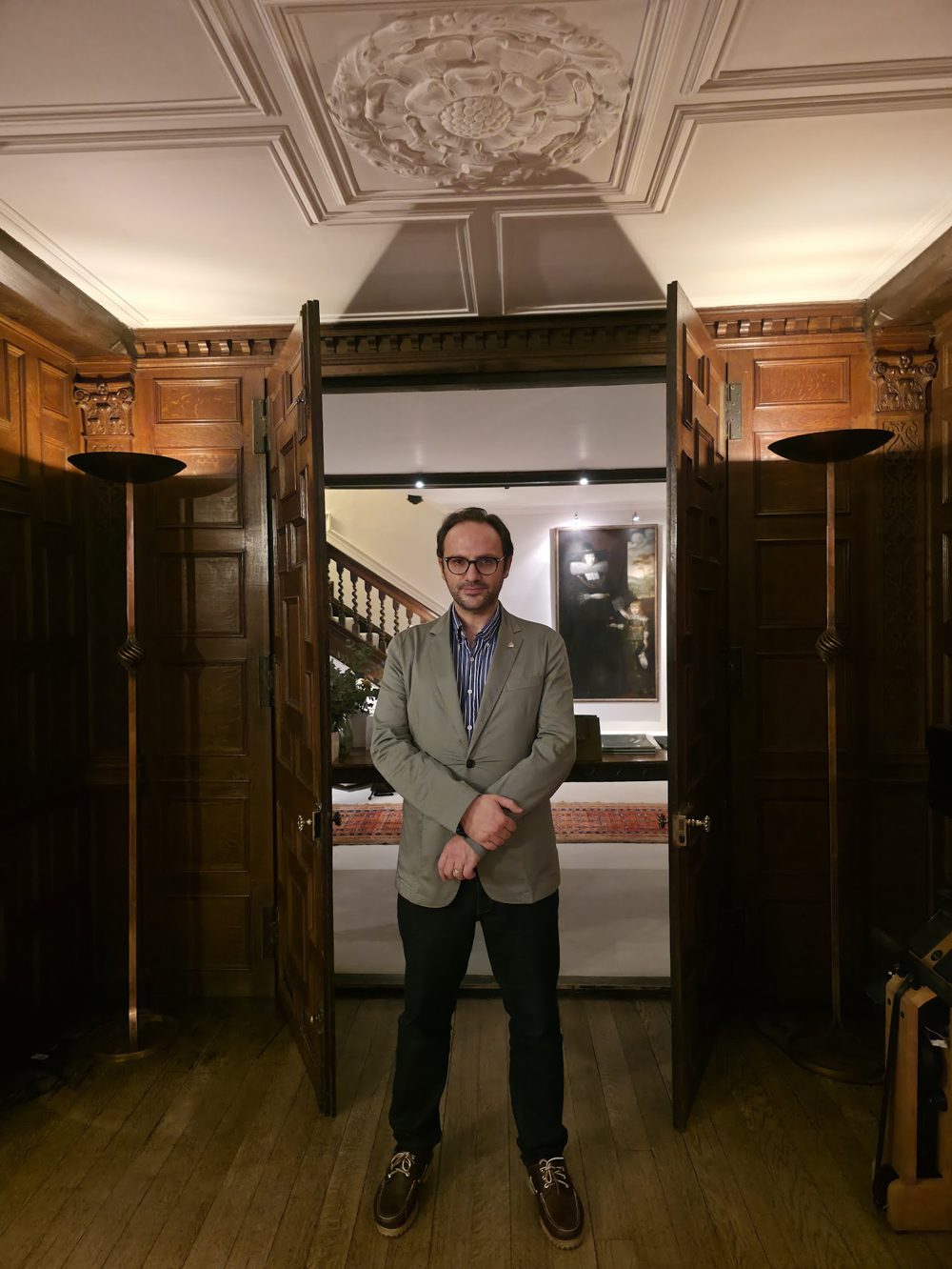 Omer Gunes, full length, in a panelled room